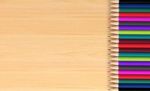 Colored Pencils On Wooden Board Stock Photo