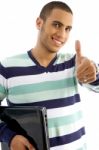 Smiling Guy Holding Notebook Showing Thumbs Up Stock Photo