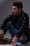 Casual Young Man In Black Leather Jacket And Denim Jeans Stock Photo