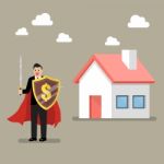 Businessman Protecting House With Shield And Sword Stock Photo