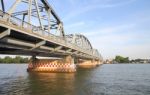 Metal Bridge Across Local River To Country Stock Photo