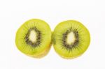 Kiwi Slices Into Half On White Background Stock Photo