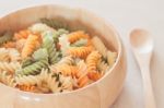 Raw Fusilli Pasta In Wooden Bowl Stock Photo