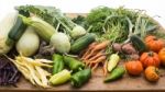 Several Vegetables On Wooden Chopping Board And Table Stock Photo