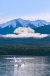 Water Plane Floating Over Fresh Water Lake Against Beautiful Mountain Scenery In Lake Te Anau New Zealand Stock Photo