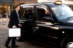 Man Opening Door Of Taxi Cab Stock Photo