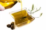 Pouring Olive Oil In Container Stock Photo