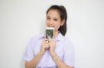 Portrait Of Thai High School Student Uniform Teen Beautiful Girl Using Her Phone And Smile Stock Photo