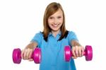 Adorable Teen Holding Dumbbells In Her Outstretched Arms Stock Photo