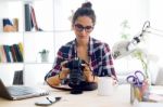 Young Woman Photographer Checking Previews On Camera In The Stud Stock Photo