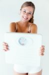 Young Girl In Underwear Holding Scales Stock Photo