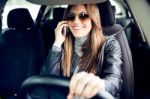 Beautiful Young Woman Using Her Mobile Phone In The Car Stock Photo