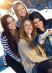 A Group Of Friends Taking Photos With A Smartphone Stock Photo