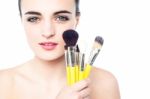 Portrait Of A Beautiful Girl With Makeup Brushes Stock Photo