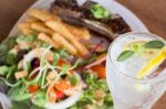 Delicious Barbecued Ribs And Lemon Soda Drink Stock Photo