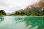 Beautiful High Mountains And Green Lake Stock Photo