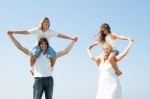 Kids ride on parents shoulder Stock Photo