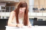 Portrait Of Thai Adult Beautiful Girl Write A Book And Smile In University Stock Photo