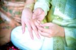 Groom Putting A Ring On Bride's Finger Stock Photo