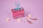 Pink Aromatic Perfume With Hairpins And Pink Pearls On Pink Background Stock Photo