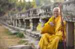 An Unidentified Old Buddhist Female Monk Dressed In Orange Toga Stock Photo