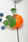 Tangerine And Blueberry On White Table Stock Photo