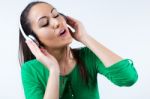 Beautiful Young Woman Listening To Music. Isolated On White Stock Photo