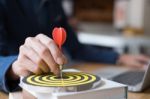 Business Man Hand Holding A Target With Darts Hitting The Center Stock Photo