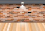 Empty Room With Wooden Floor On Brick Wall Stock Photo