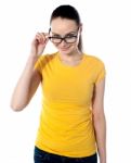 Young Woman Peering Over Glasses Stock Photo