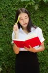 Thai Adult Student University Beautiful Girl Reading Red Book Stock Photo