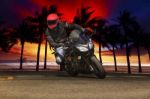 Young Man Riding Big Bike Motorcycle On Asphalt Roads Against Be Stock Photo