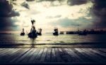 Wooden Pier With Many Fishing Boat In The Sea Stock Photo