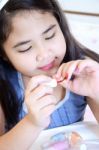 Little Girl With A Pastel Color And Red Nail Polish Stock Photo