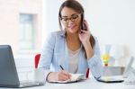 Pretty Young Woman Working In Her Office Stock Photo