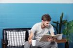 Men Drinking Coffee,reading A Book And Relax In Living Room Stock Photo