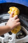 Outdoor Tire Car Wash With Yellow Sponge Stock Photo