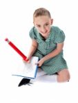 Sitting Schoolgirl Doing Homework Stock Photo