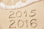 2015 2016 Inscription Written In The Wet Yellow Beach Sand Being Stock Photo