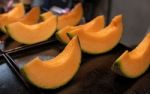 Cutting Japanese Melon Stock Photo