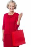 Senior Woman Holding Red Shopping Bag Stock Photo