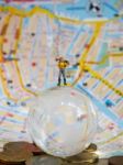 Miniature Traveller Or Backpacker Stand On Globe Of Glass, Euro Stock Photo