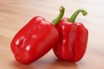 Two Red Sweet Peppers On The Table Stock Photo