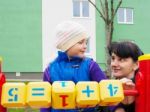 Mom Teaches Daughter To Be Considered With Wooden Cubes Stock Photo