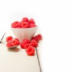 Bunch Of Fresh Raspberry On A Bowl And White Table Stock Photo