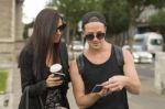 Cheerful Friends Taking Photos Of Themselves On Smart Phone Stock Photo