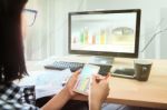 Woman Working On Smart Phone And Office Computer Pc Stock Photo