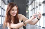 Portrait Of Thai Adult Beautiful Girl Using Her Smart Phone Selfie Stock Photo