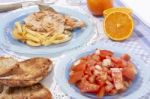 Turkey Steak With French Fries And Tomato Salad Stock Photo