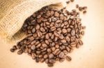 Coffee Roasted Bean In The Sack On Wooden Background Stock Photo